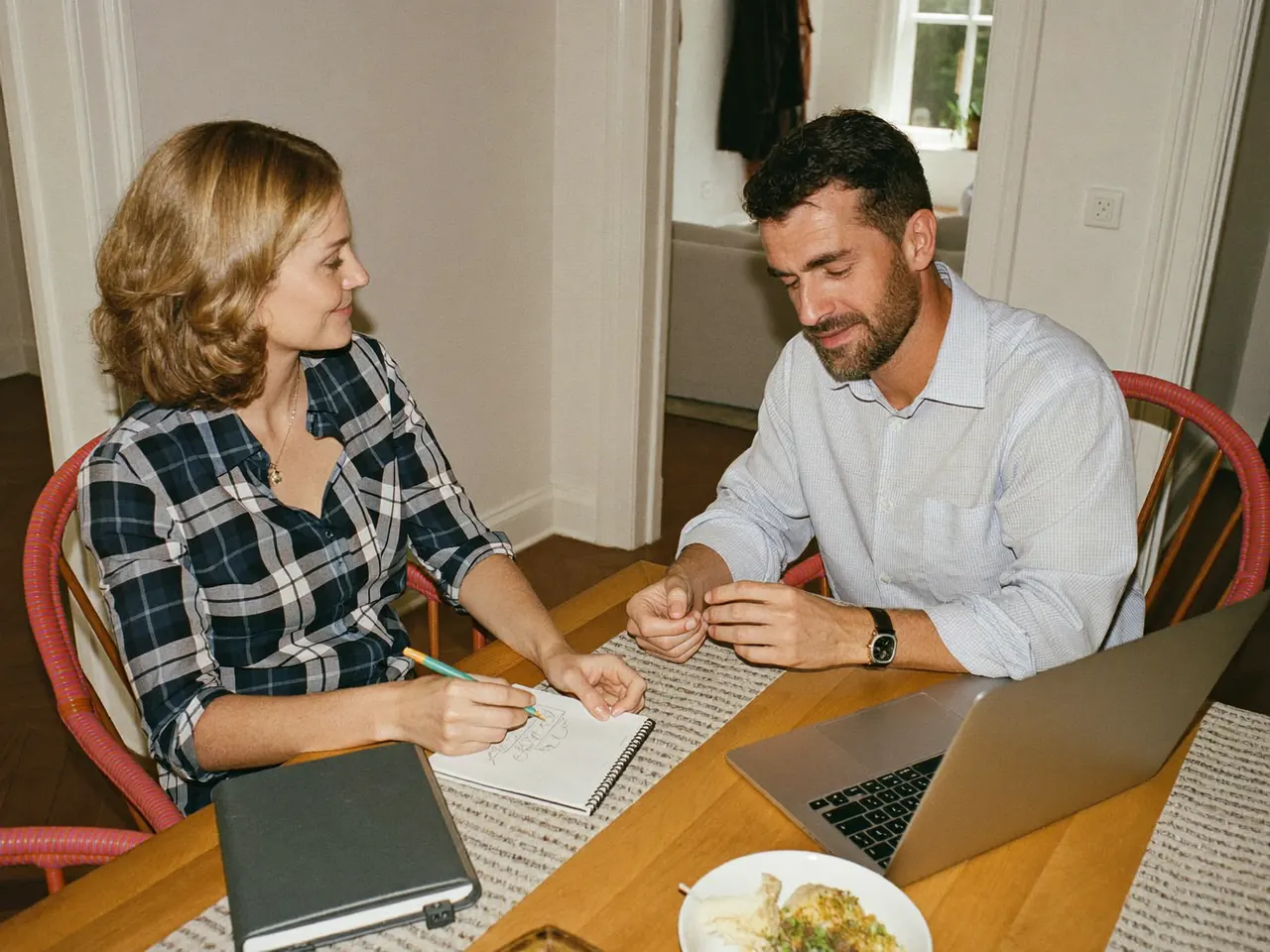 Couple planning a home improvement budget with a laptop at home