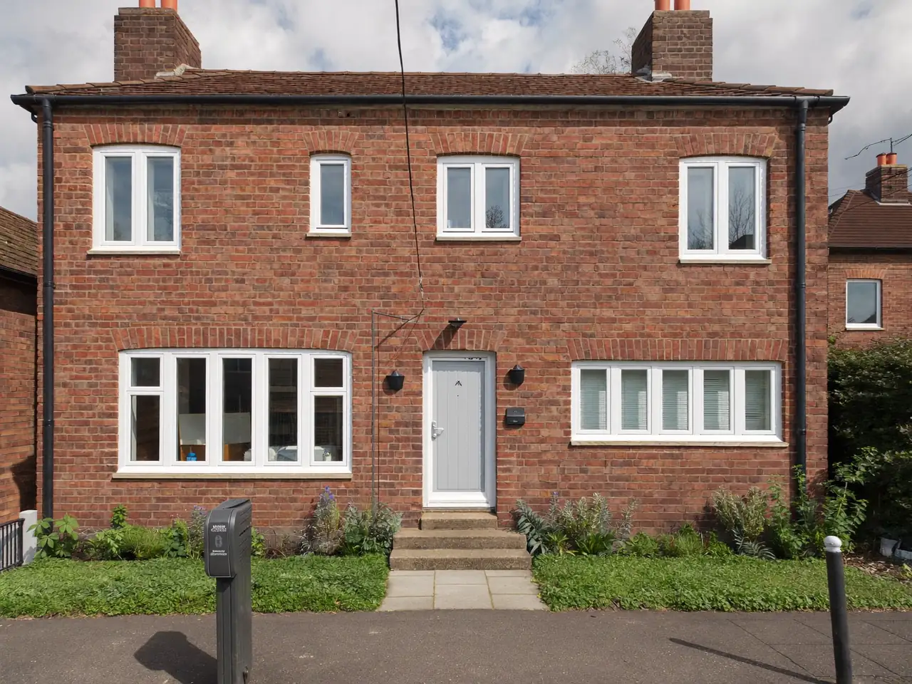 New white windows fitted to a modest brick terraced home